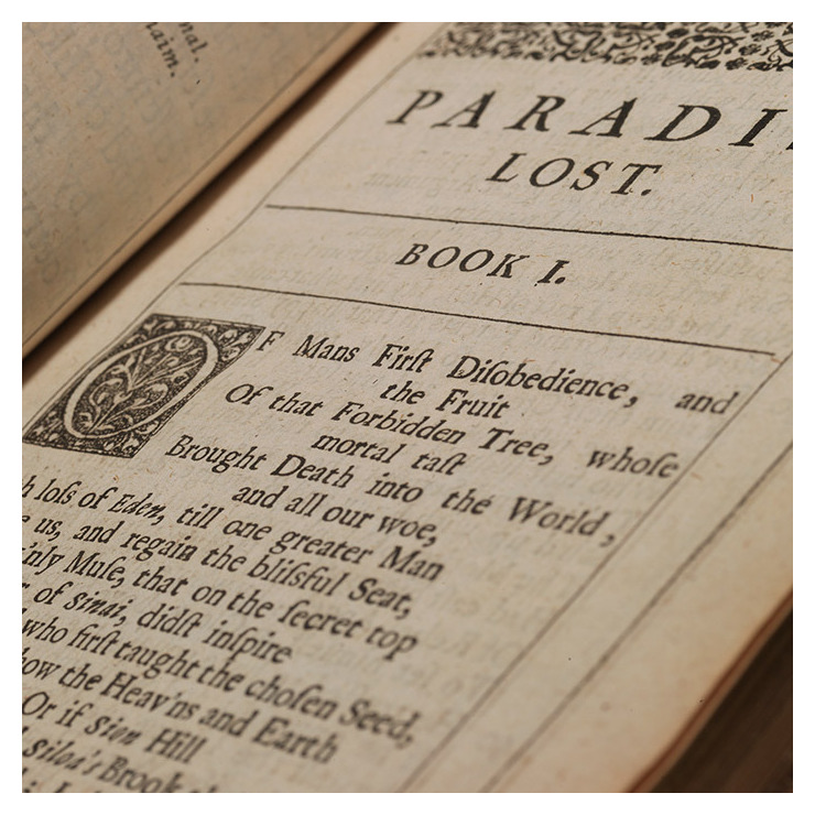 An old copy of Paradise Lost, open showing text