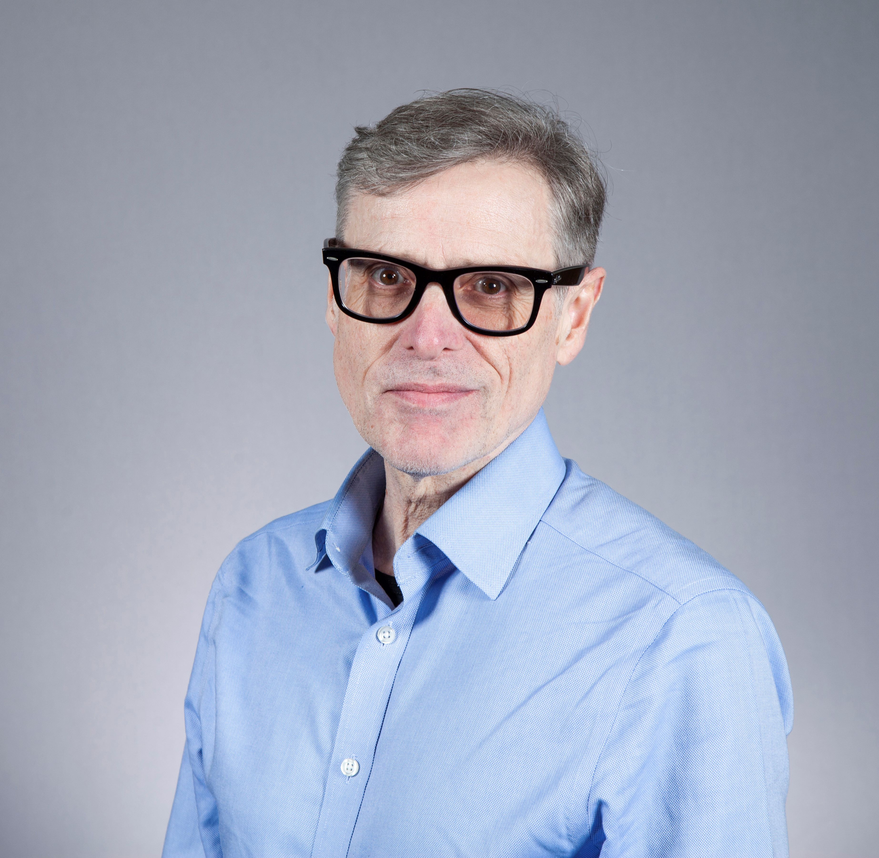 Mark Girolami headshot with glasses and a blue shirt