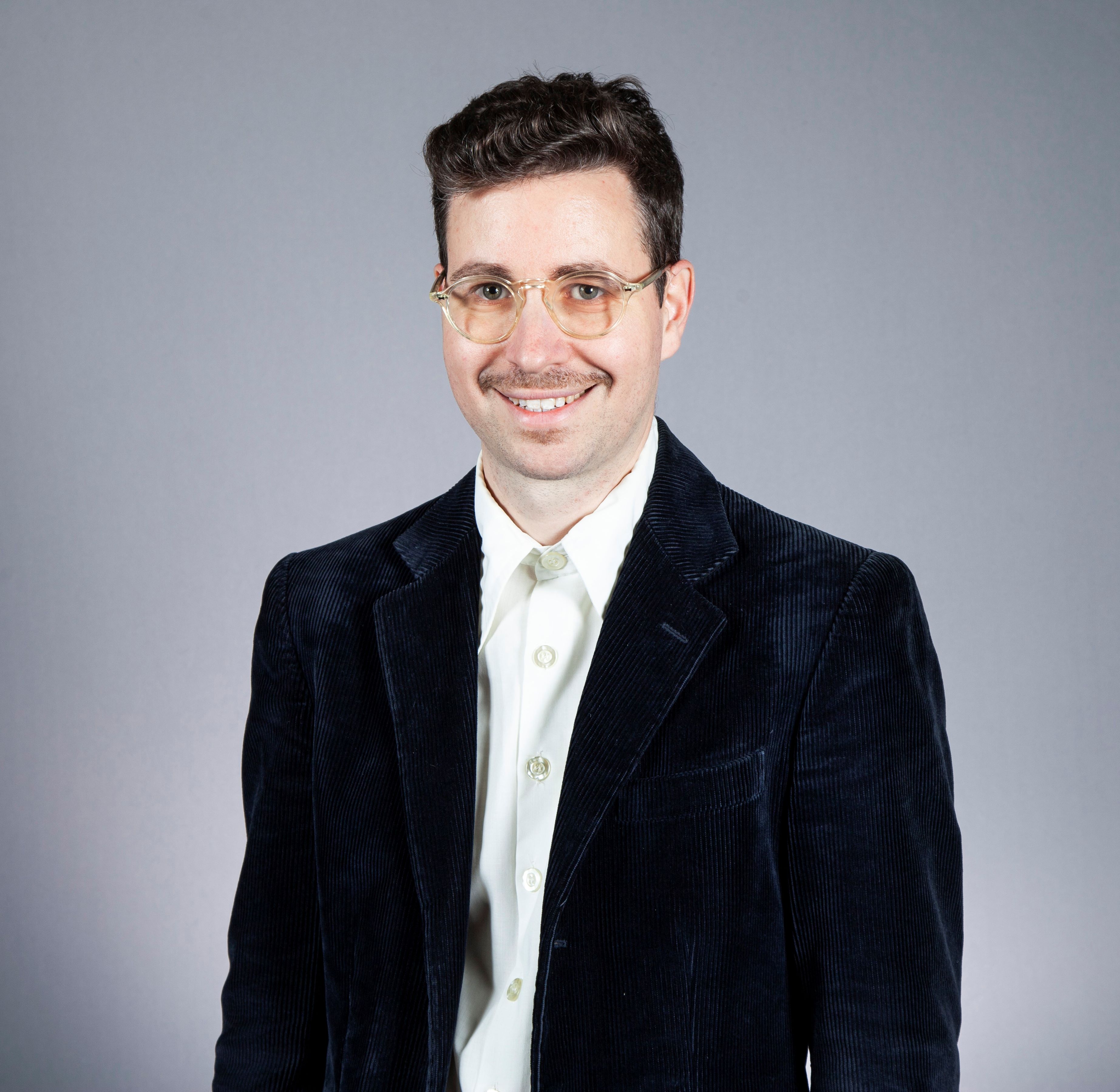 Ori Mautner headshot wearing black jacket and glasses