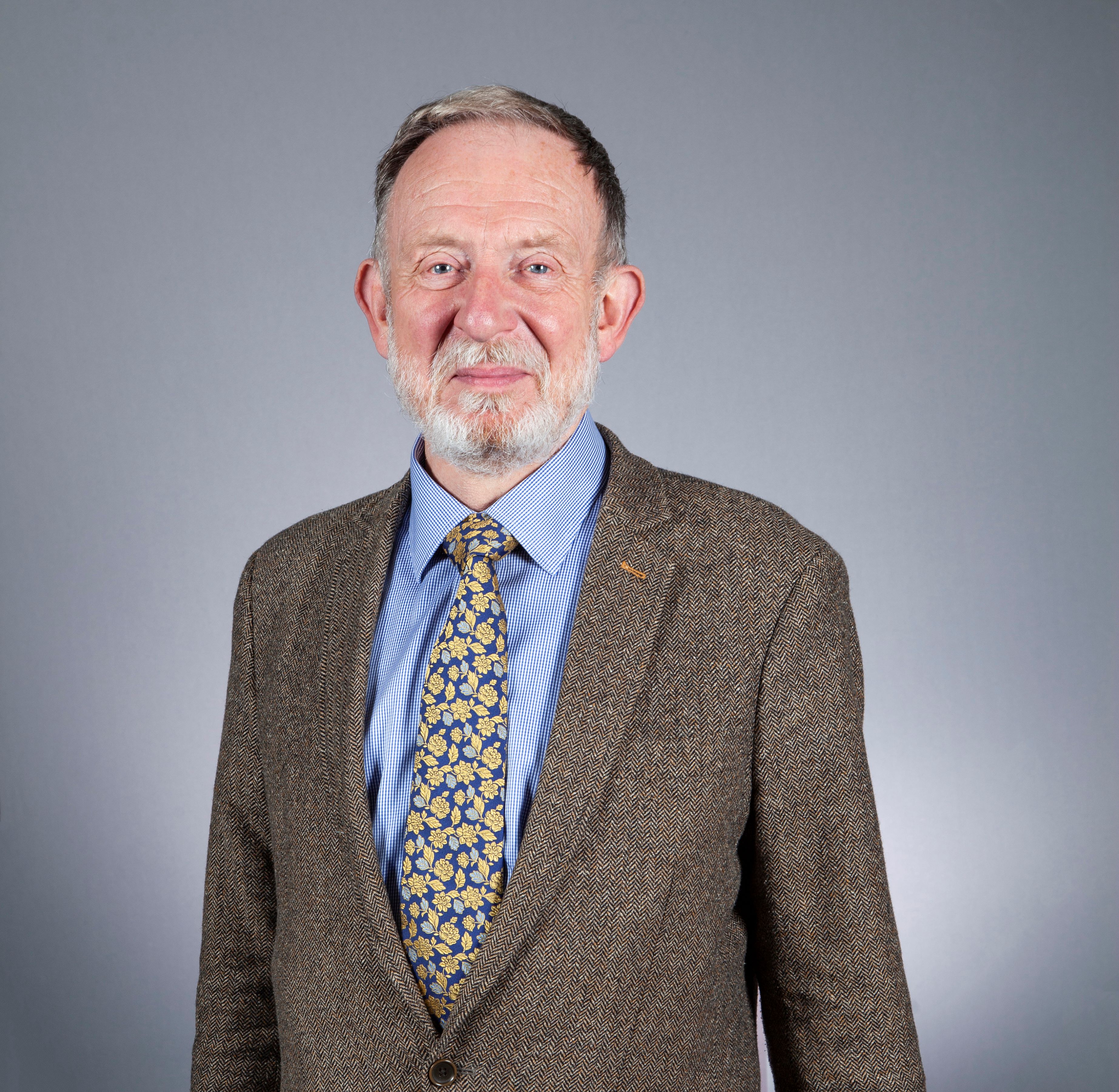 Smiling person in jacket and tie