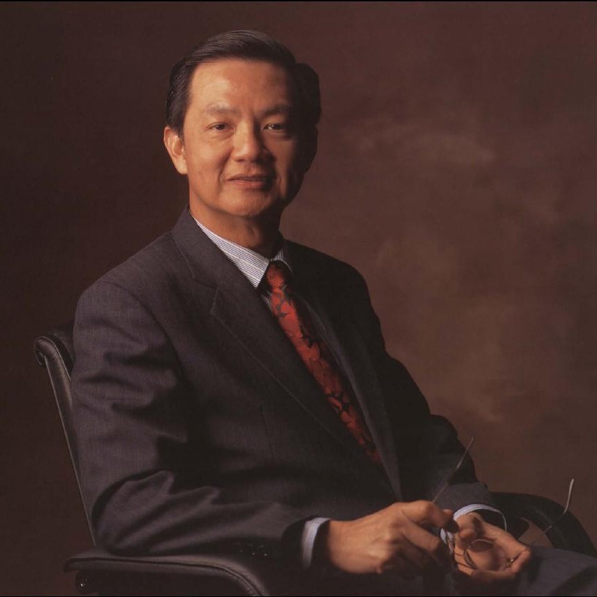 Portrait of Yeo Ning Hong, seated, dark suit, red tie, holding glasses in his hand