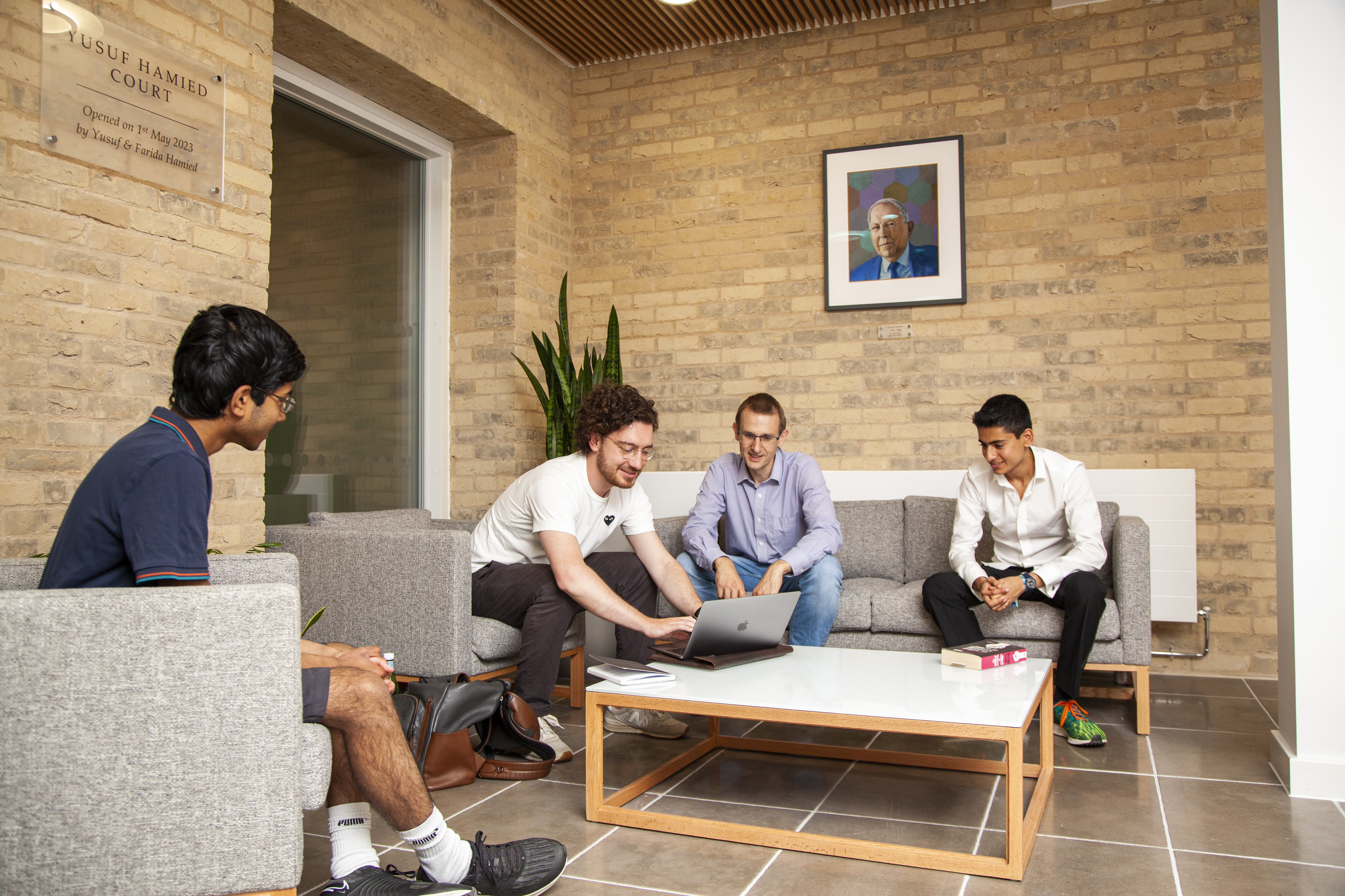 Group gathered around laptop