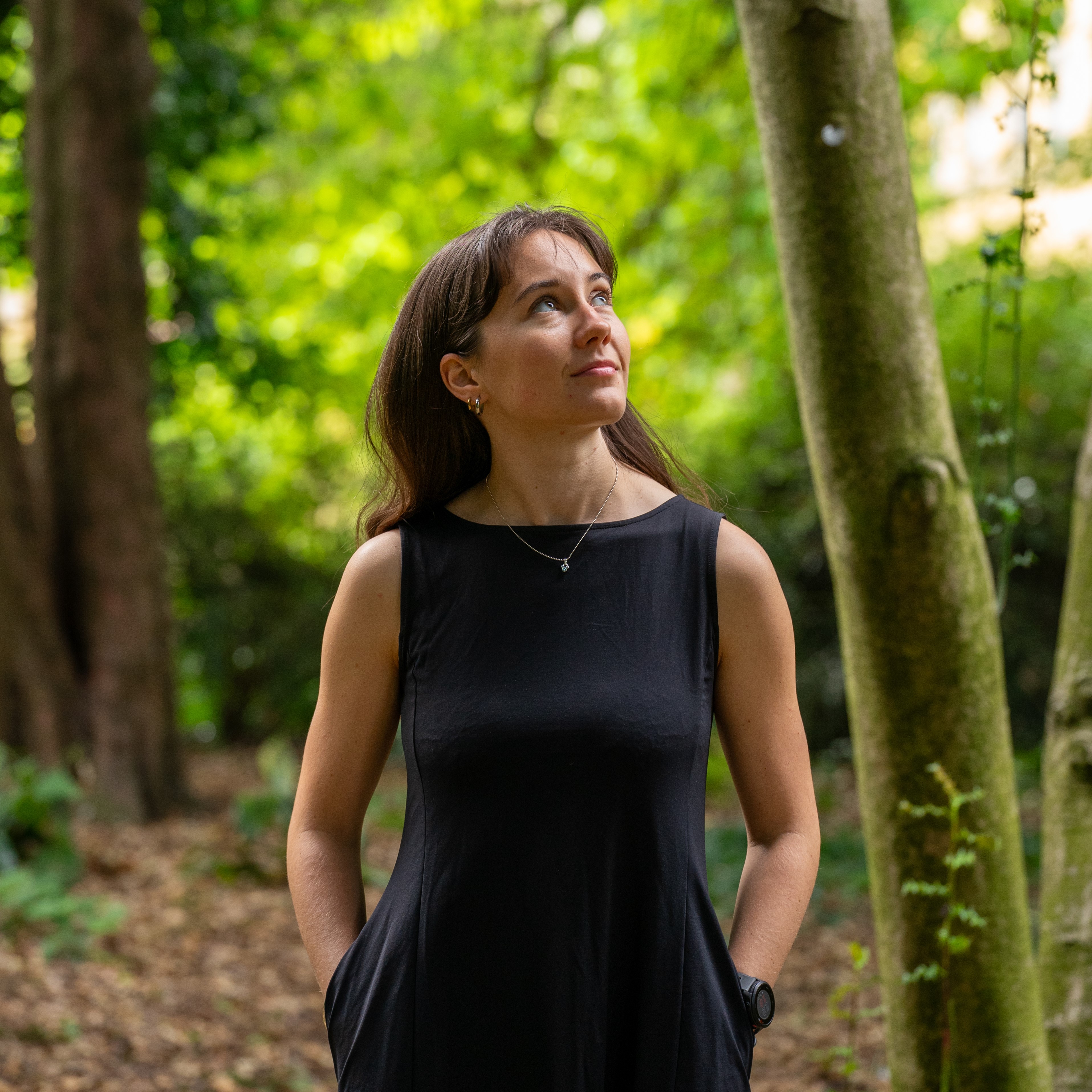 Person against a background of green trees