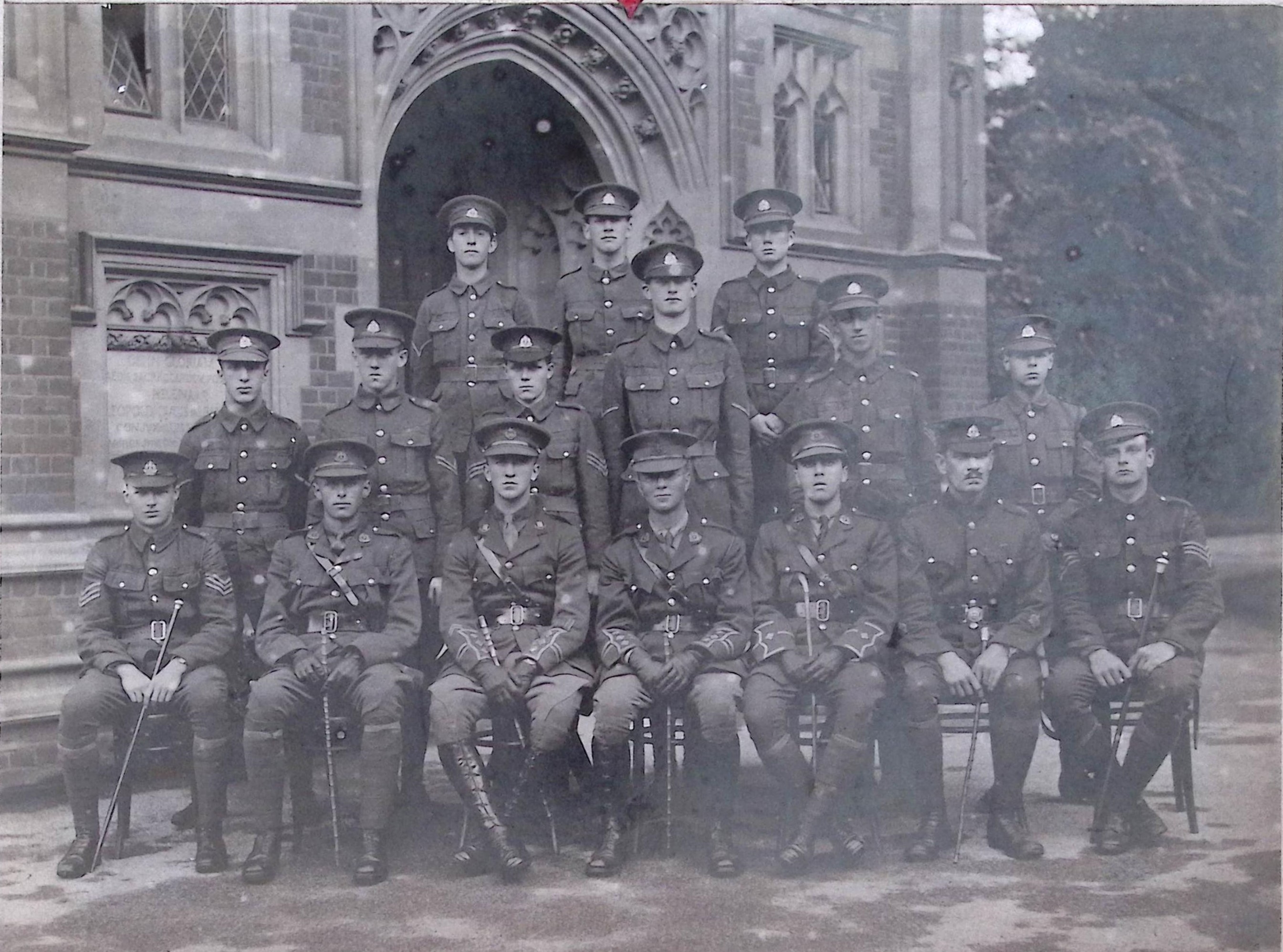 Officers in front of old building