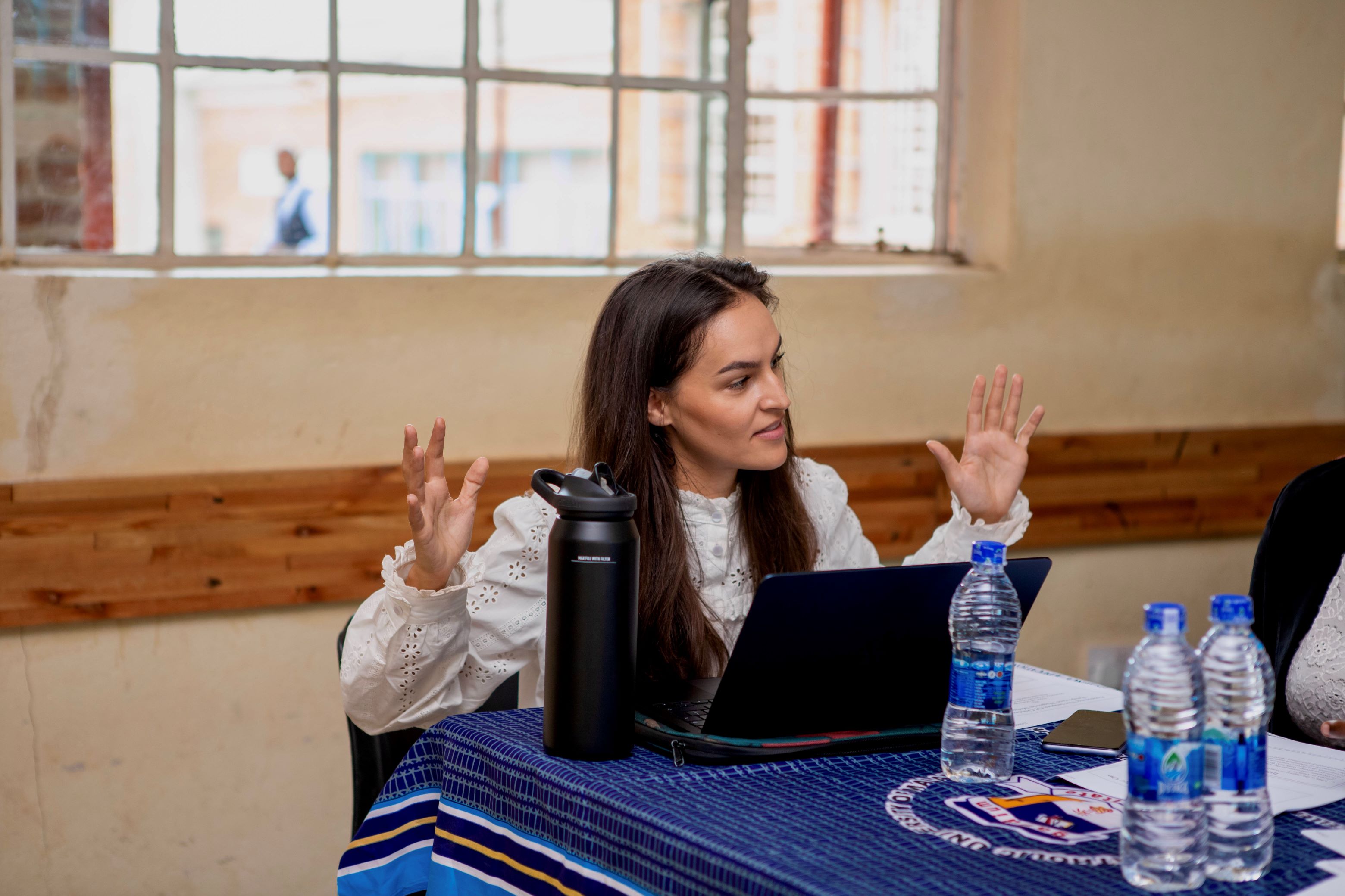 Person sitting at a table with a laptop