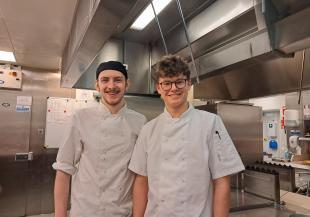 Two people in white chef's uniforms