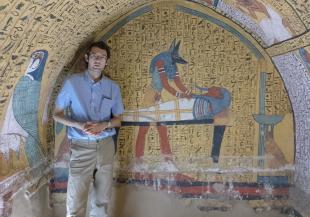 Alex Loktionov standing in front of hieroglyphs