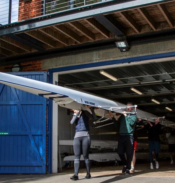 Boat being carried out of the boathouse