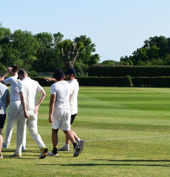 Students walking onto cricket pitch