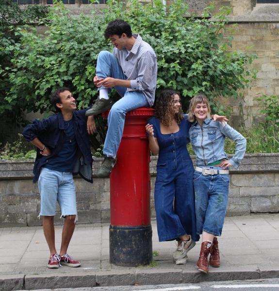 four people around a post box