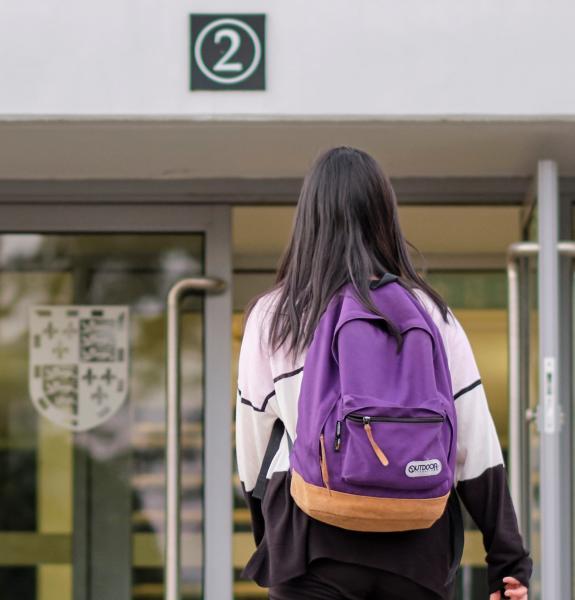 Student walking towards staircase 2 entrance