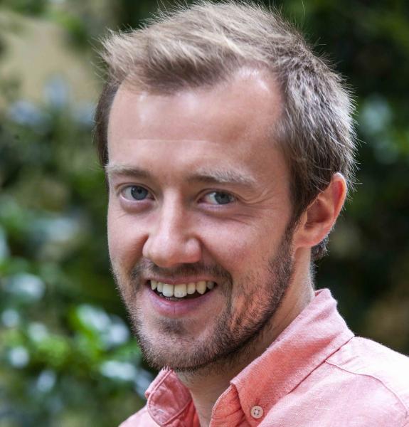 Smiling person in pink shirt