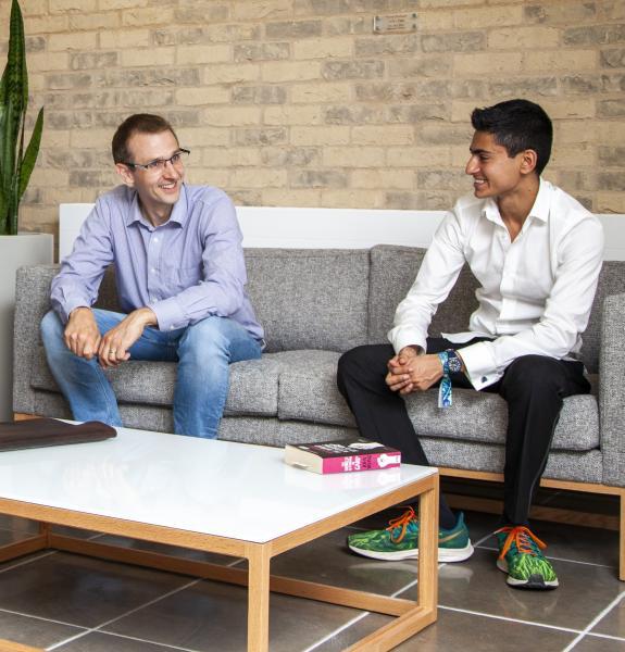 Two people chatting on a sofa