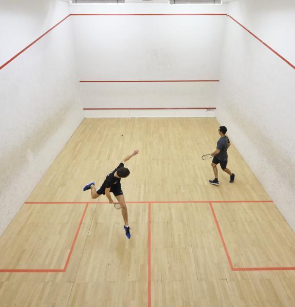 Two people playing squash