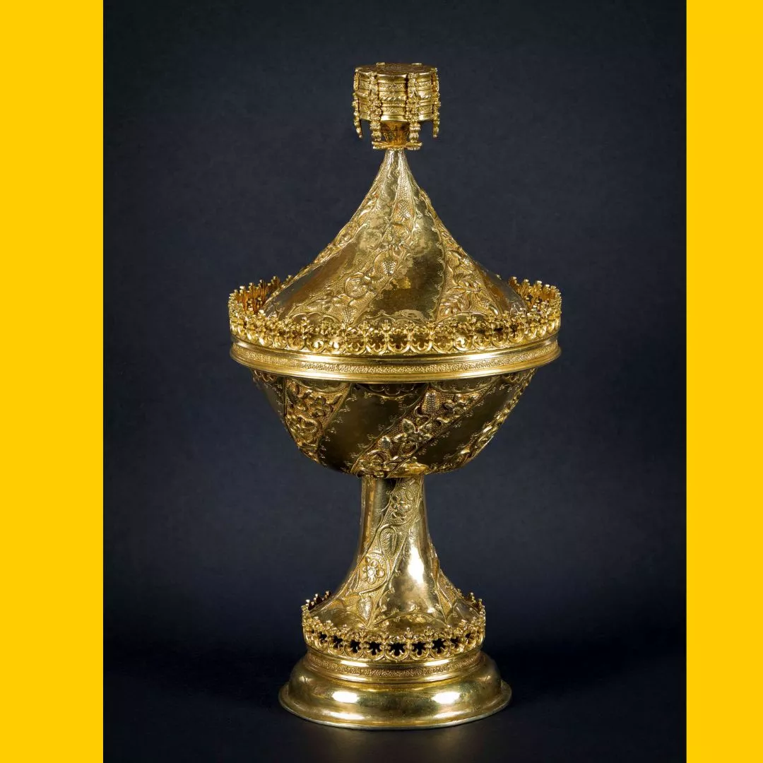 Ornate gilt cup against dark background