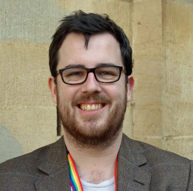 Lewis Graham headshot with glasses and a beard